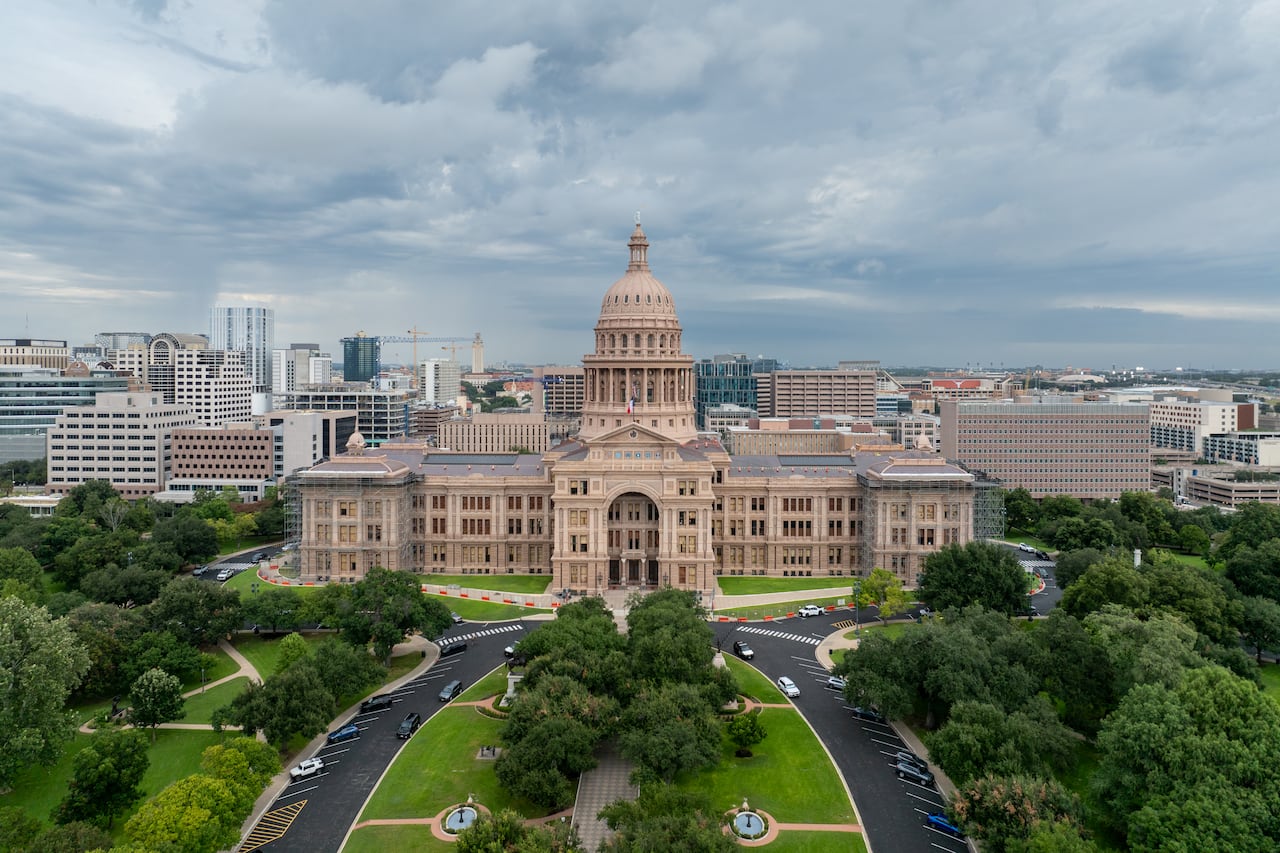 An aerial shows a large government building.