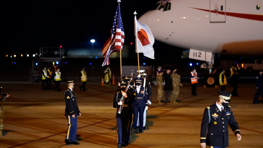 U.S. Armed Services Honor Guard moves into position as Japanese Prime Minister Yoshihide Suga arrives at Andrews Air Force Base, Md., Thursday, April 15, 2021. (AP Photo/Manuel Balce Ceneta)