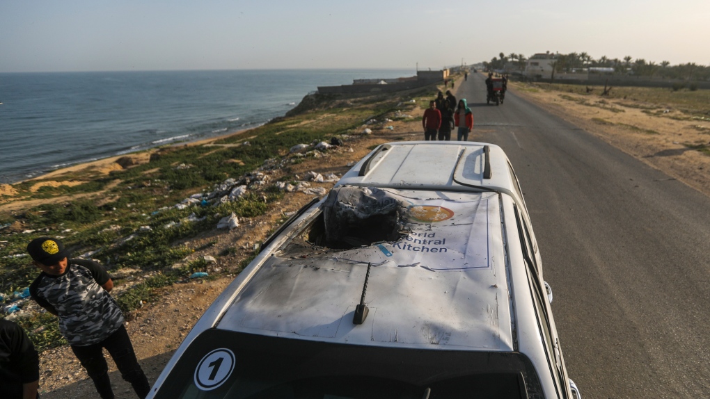 Palestinians inspect a vehicle with the logo of the World Central Kitchen wrecked by an Israeli airstrike in Deir al Balah, Gaza Strip, April 2, 2024. (AP Photo/Ismael Abu Dayyah, File)