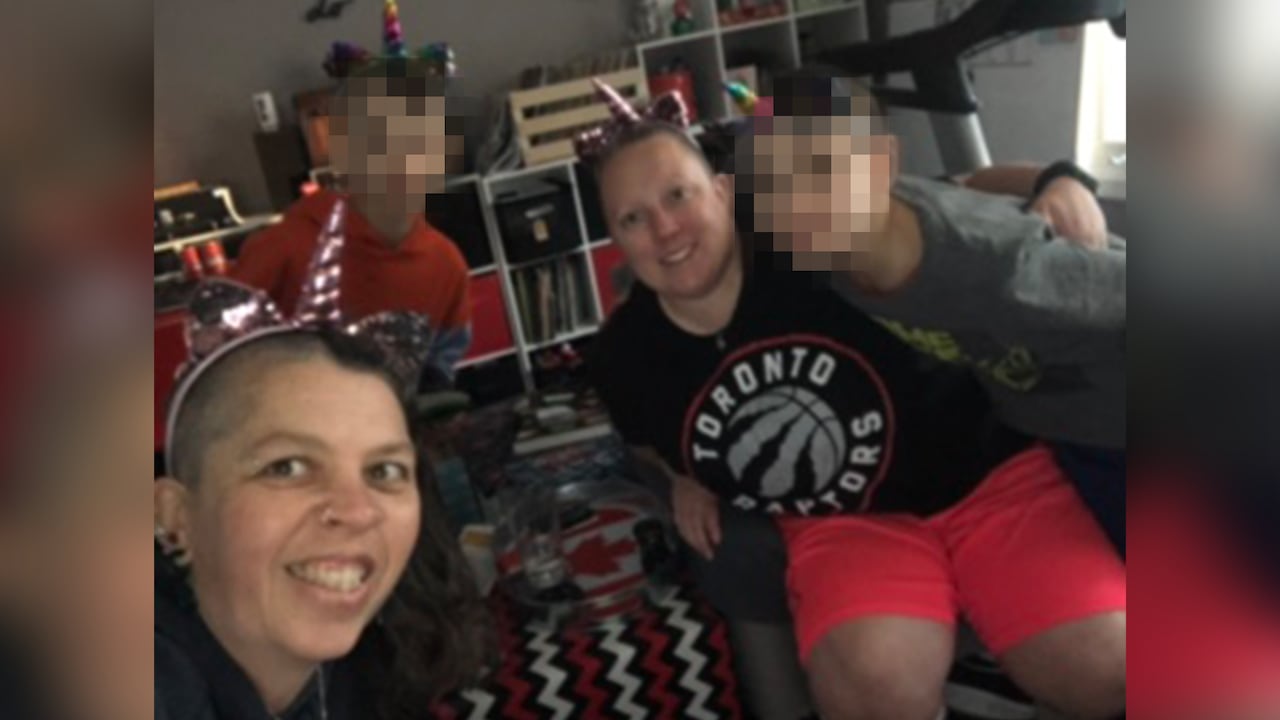 two women, two boys smiling