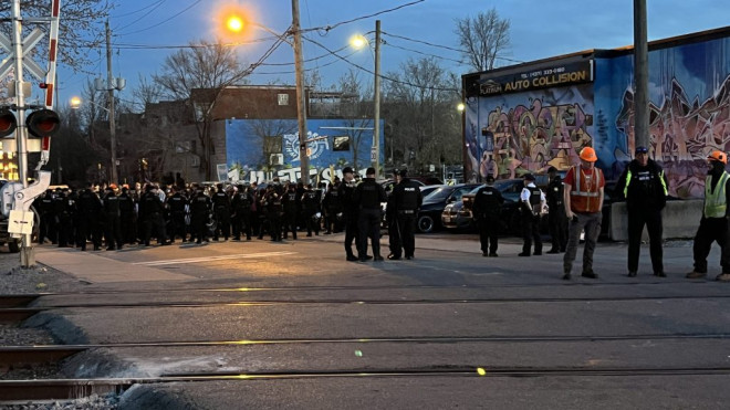 Police officers are on the scene after a pro-Palestinian protest block a rail line in Toronto.