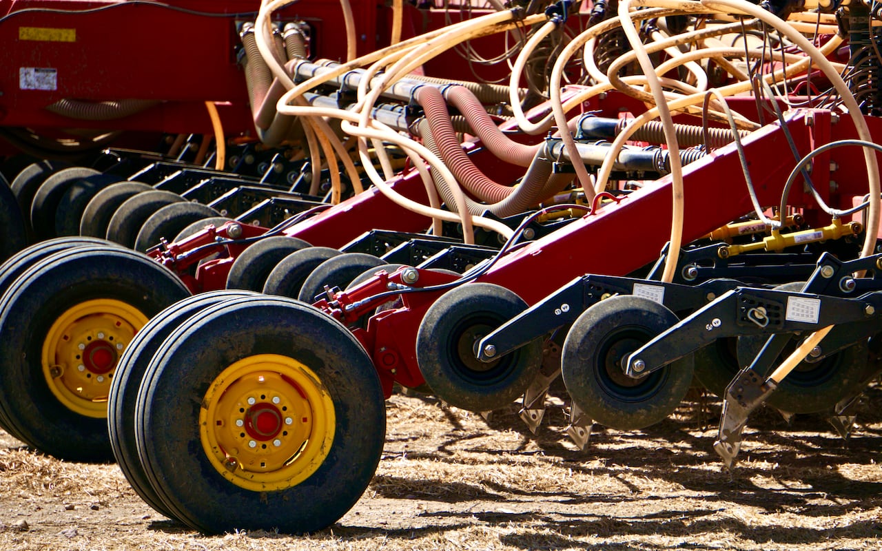 A seeder is shown on a field in Southern Alberta.