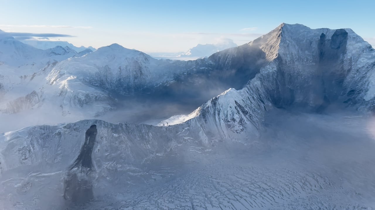 Two dark spots appear on a mountain range