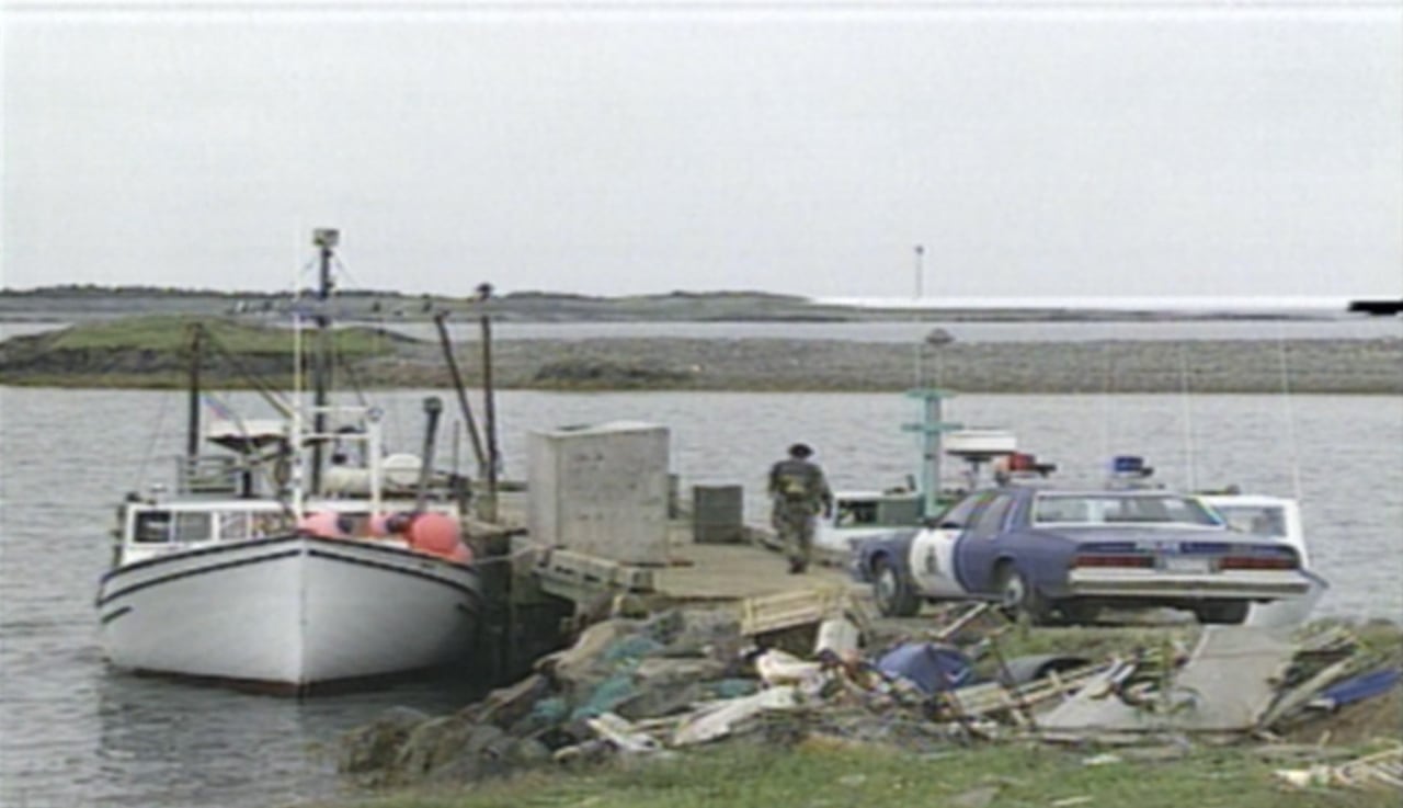 A 12-metre boat is shown at a tiny wharf. There's also an RCMP vehicle in the photo.