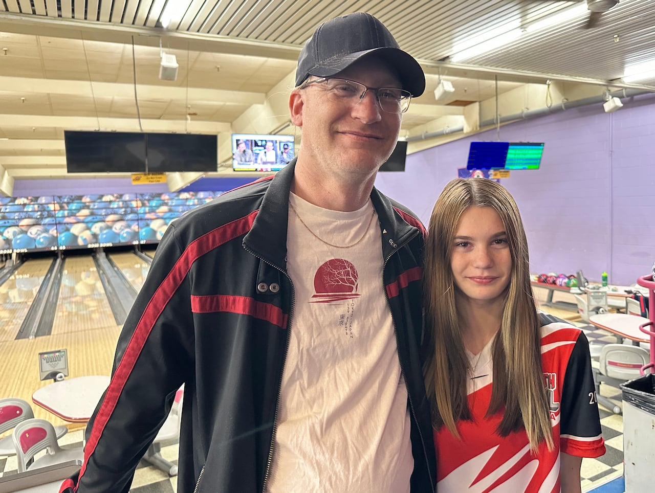 A guy in a cap, next to his daughter.