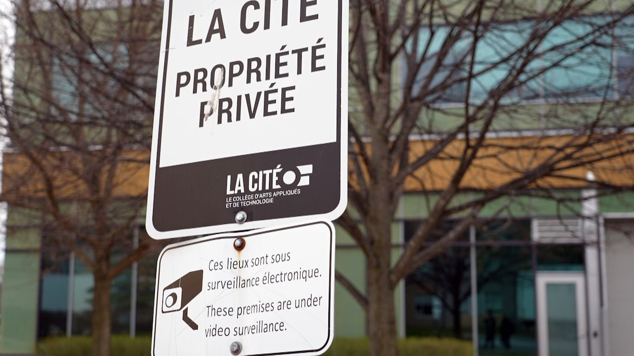 A sign on college grounds that says, 'These premises are under video surveillance.'