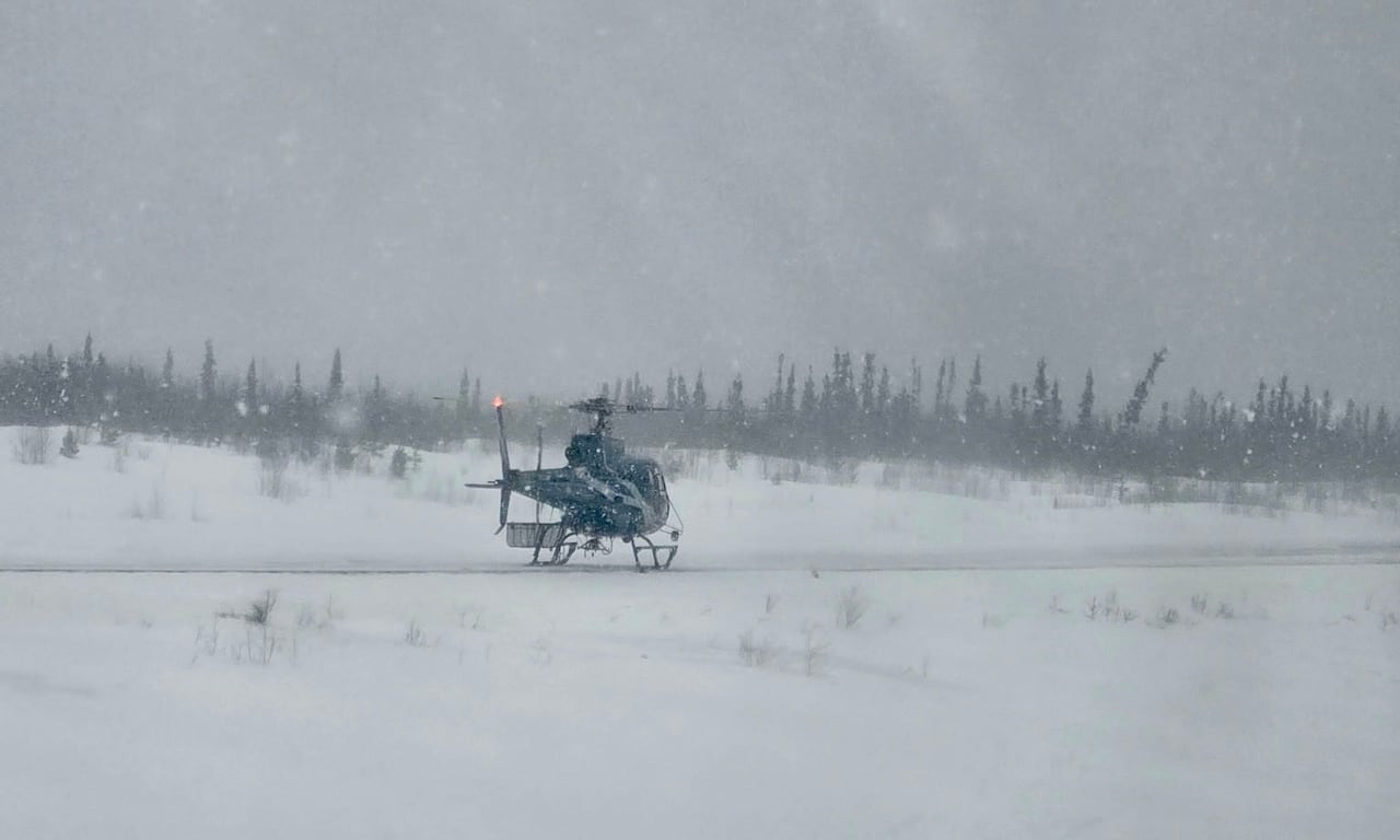 A helicopter on the side of the road.