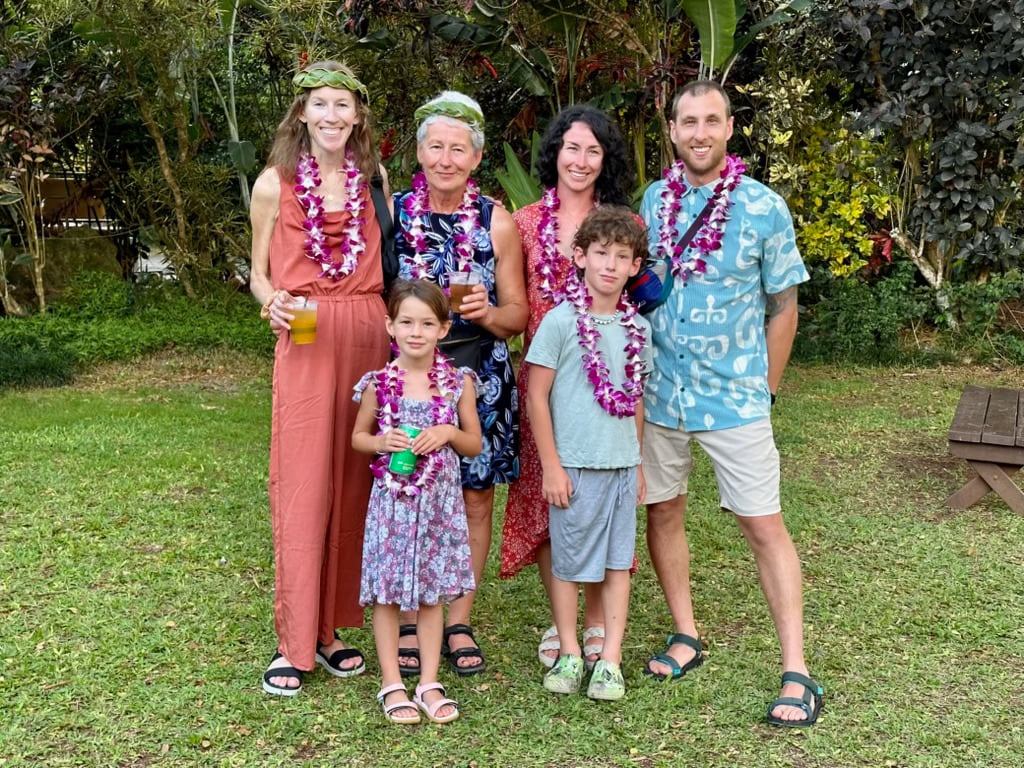 A group of people standing in front of trees