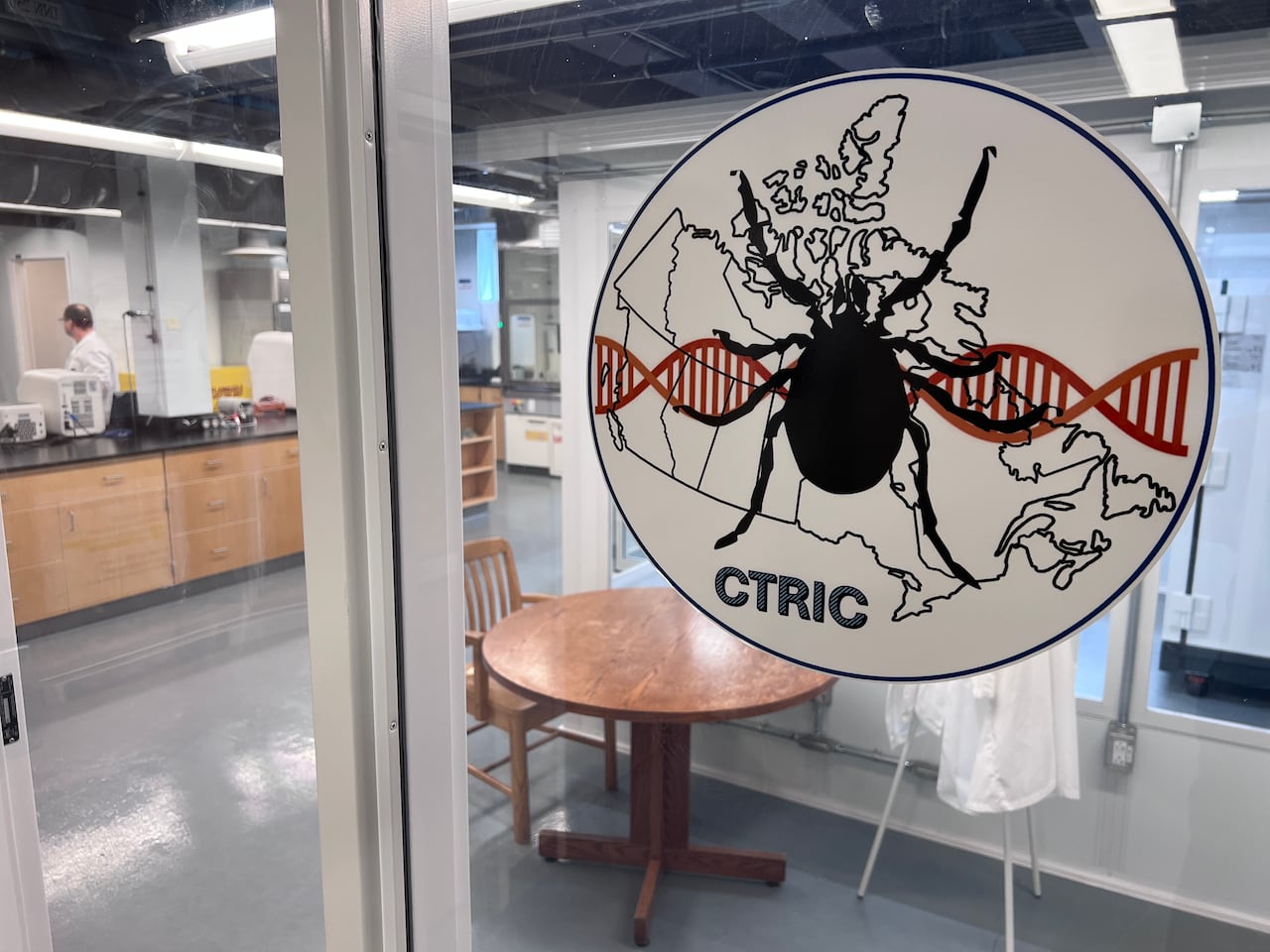 A circular sign with a graphic of a tick on it