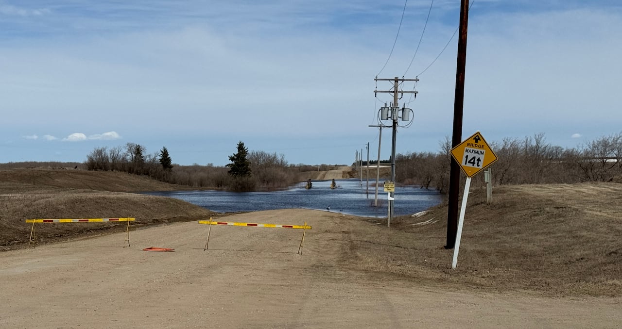 Water over a gravel road.