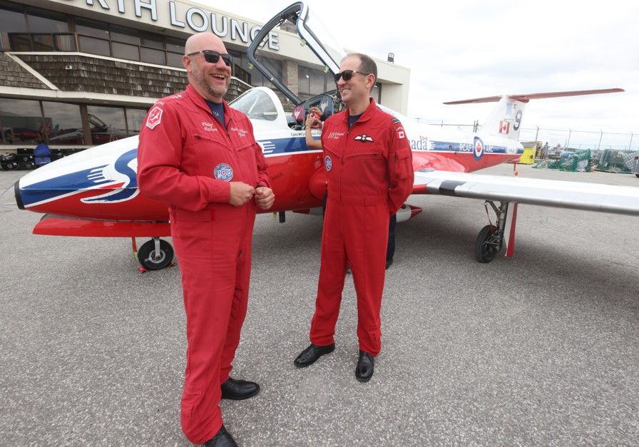 Snowbirds public affairs officer Capt. Philip Rochon (L) and Capt. Edward Soye, of Snowbird 10, speak on Thursday, Aug. 29, 2024, in front of one of the planes that will fly over the CNE this weekend during the 75th Canadian International Air Show.
