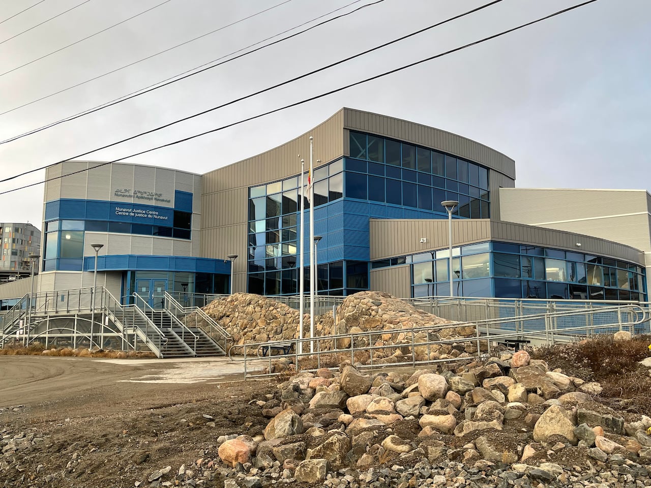 The outside of a courthouse with rock formations in the foreground