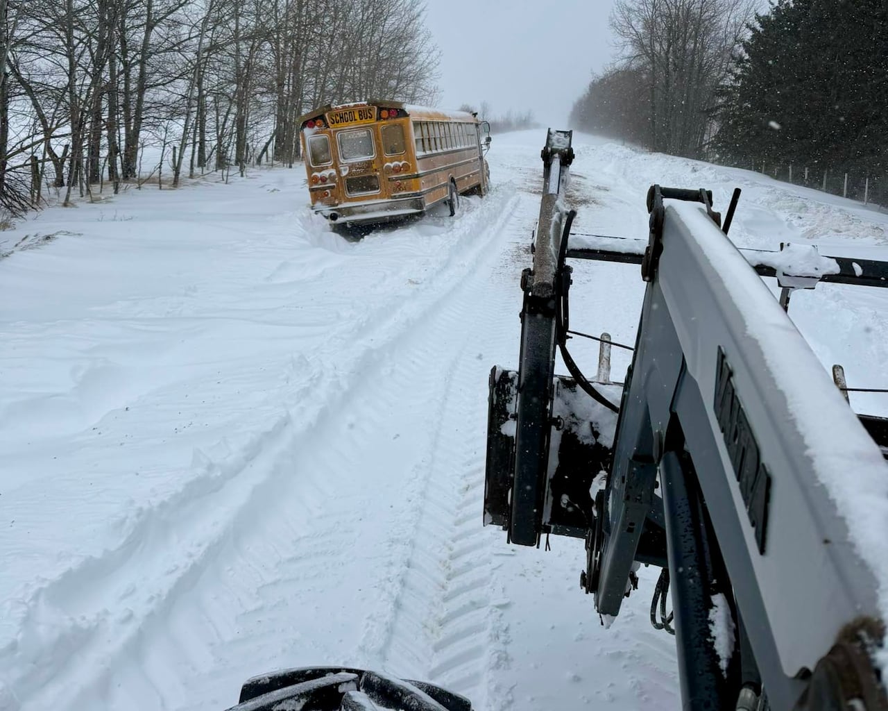 A bus on the side of a snowy road.