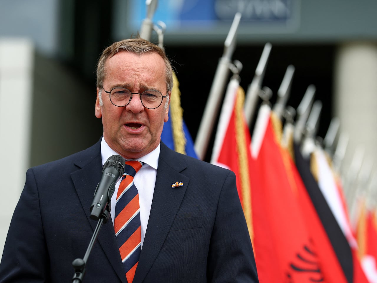 A man speaks at a microphone
