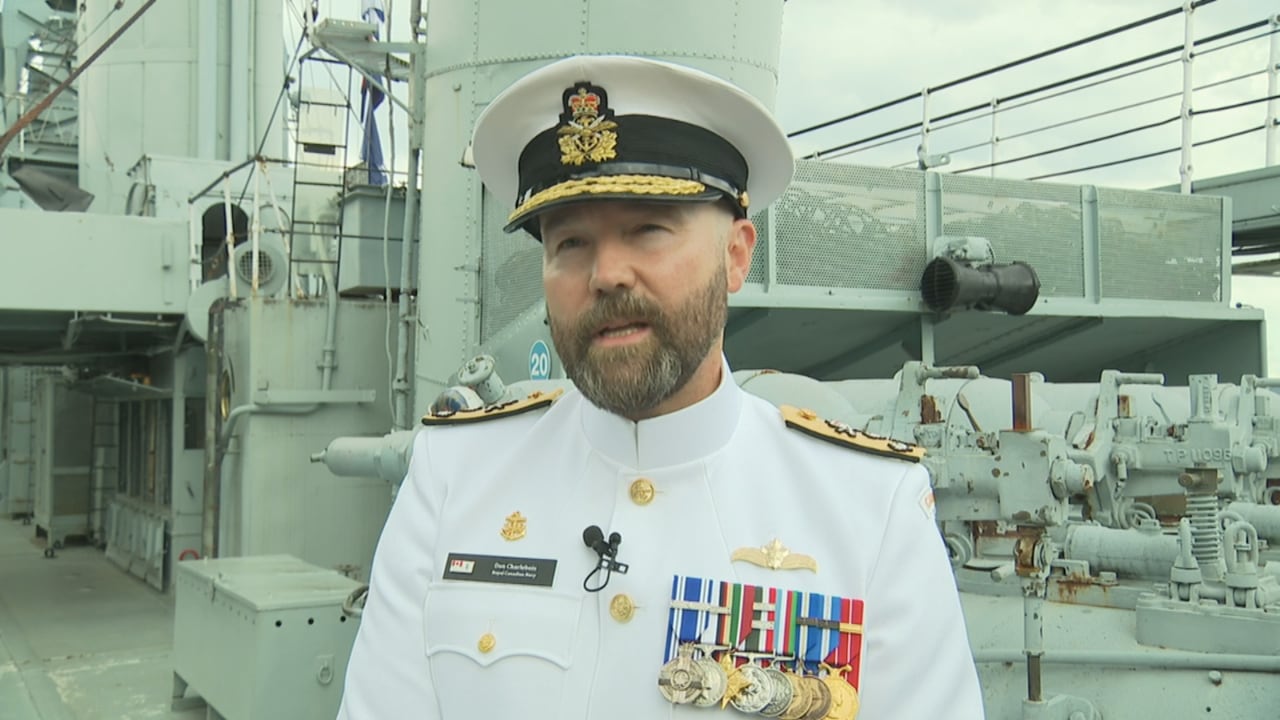 A man in a navy uniform.