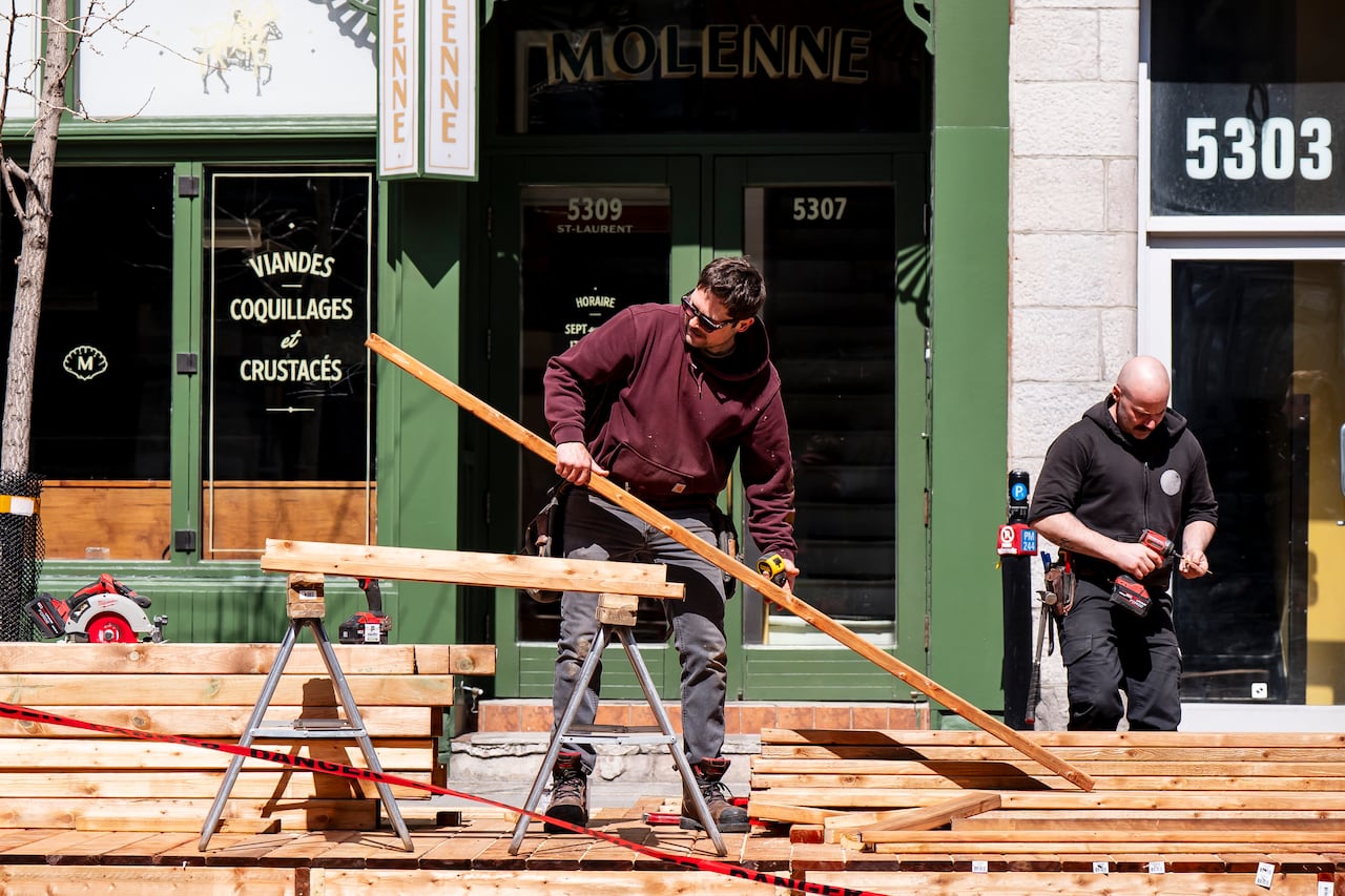 Carpenters construct a patio in Old Montreal