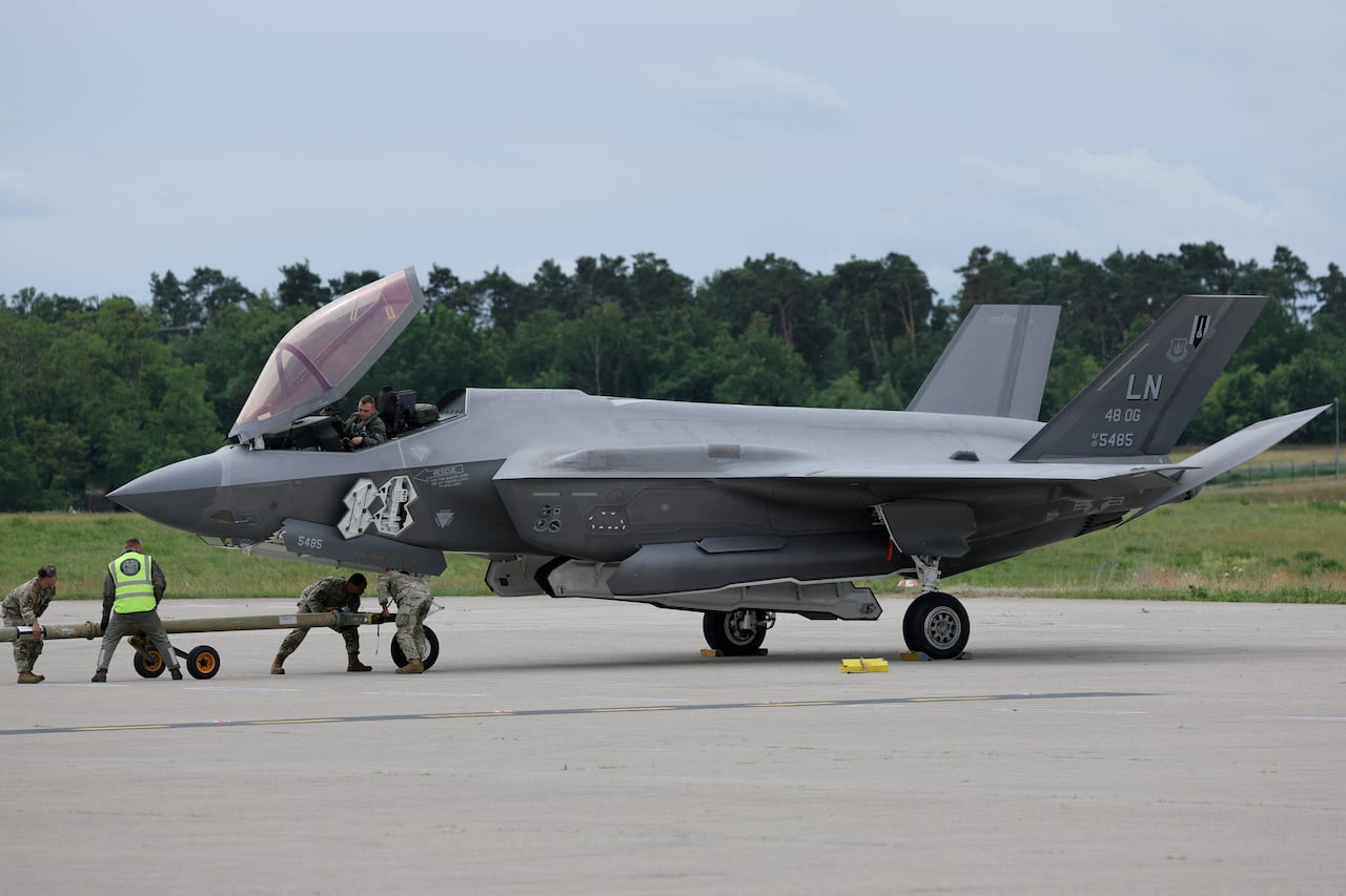 A jet is seen on an airfield.