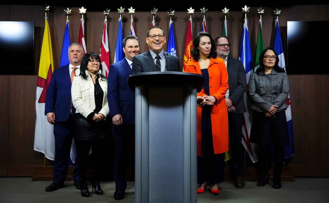 NDP Leader Avi Lewis, centre, speaks during a press conference with his party