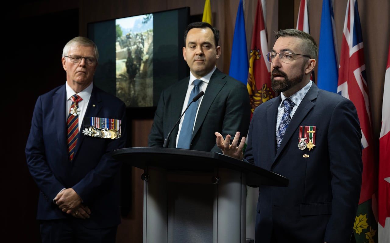 Three men stand at a podium.