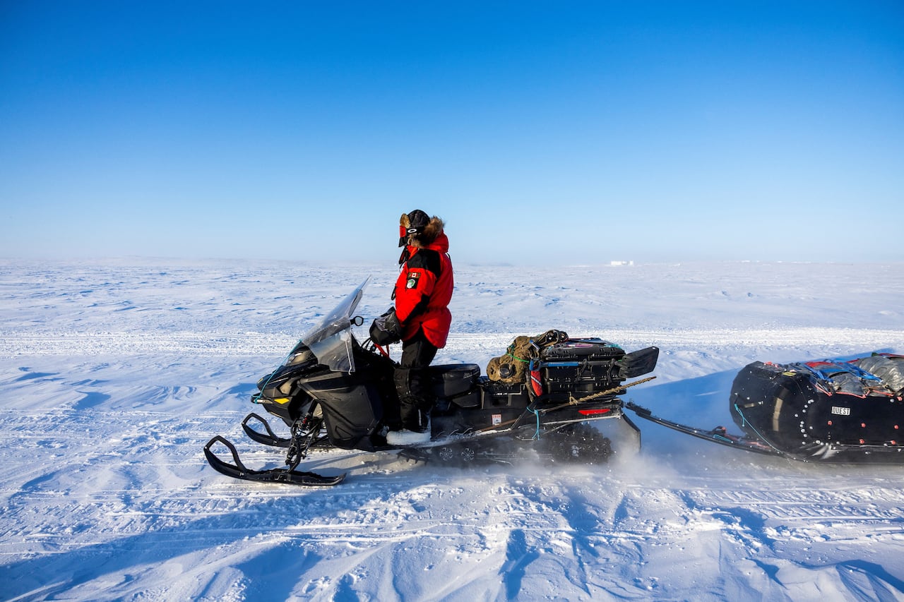 A Canadian Ranger on a skidoo in the Arctic.