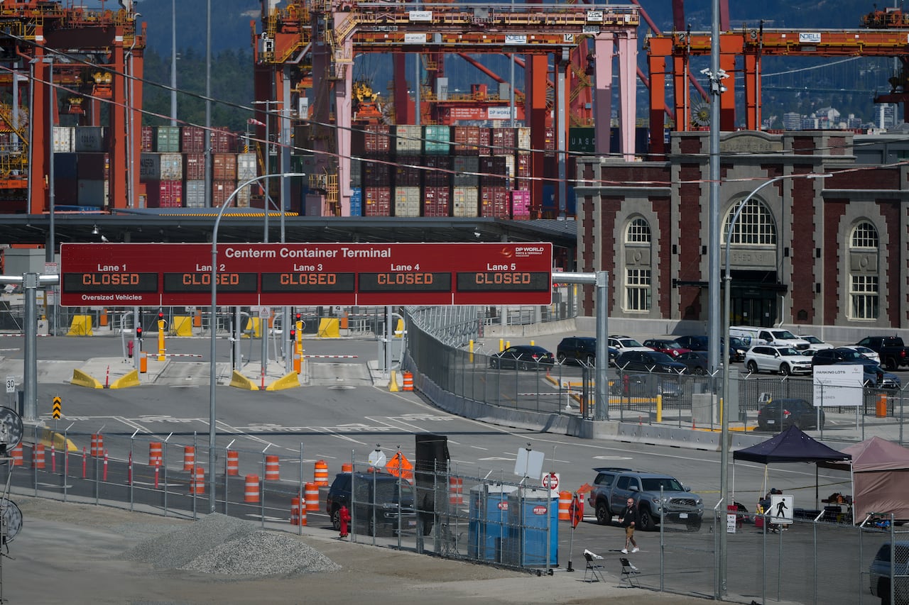 Signs displaying "closed" are seen at the Centerm Container Terminal as striking International Longshore and Warehouse Union Canada workers picket at the port, in Vancouver, B.C.