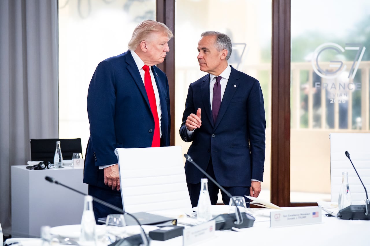 Two men in suits standing.