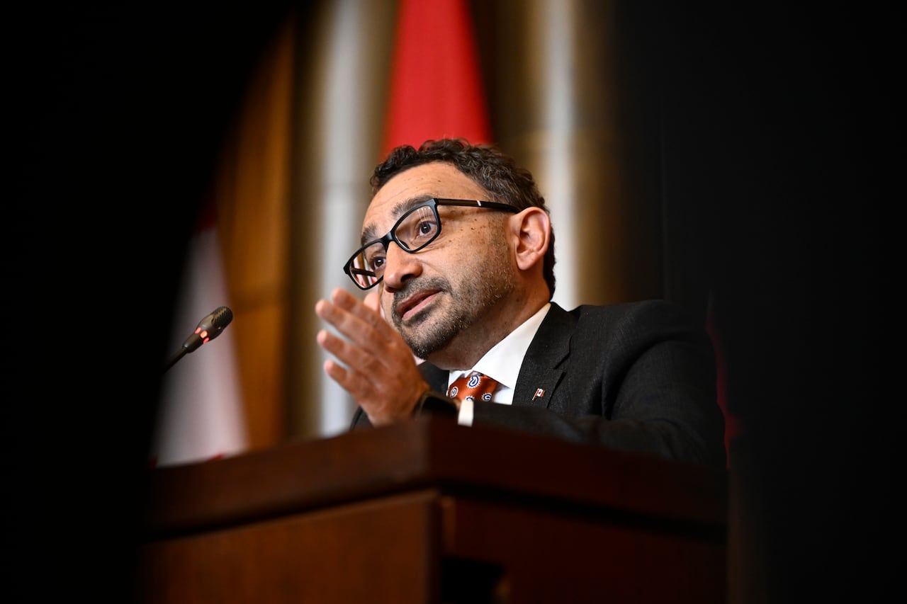 Omar Alghabra speaking to journalists.