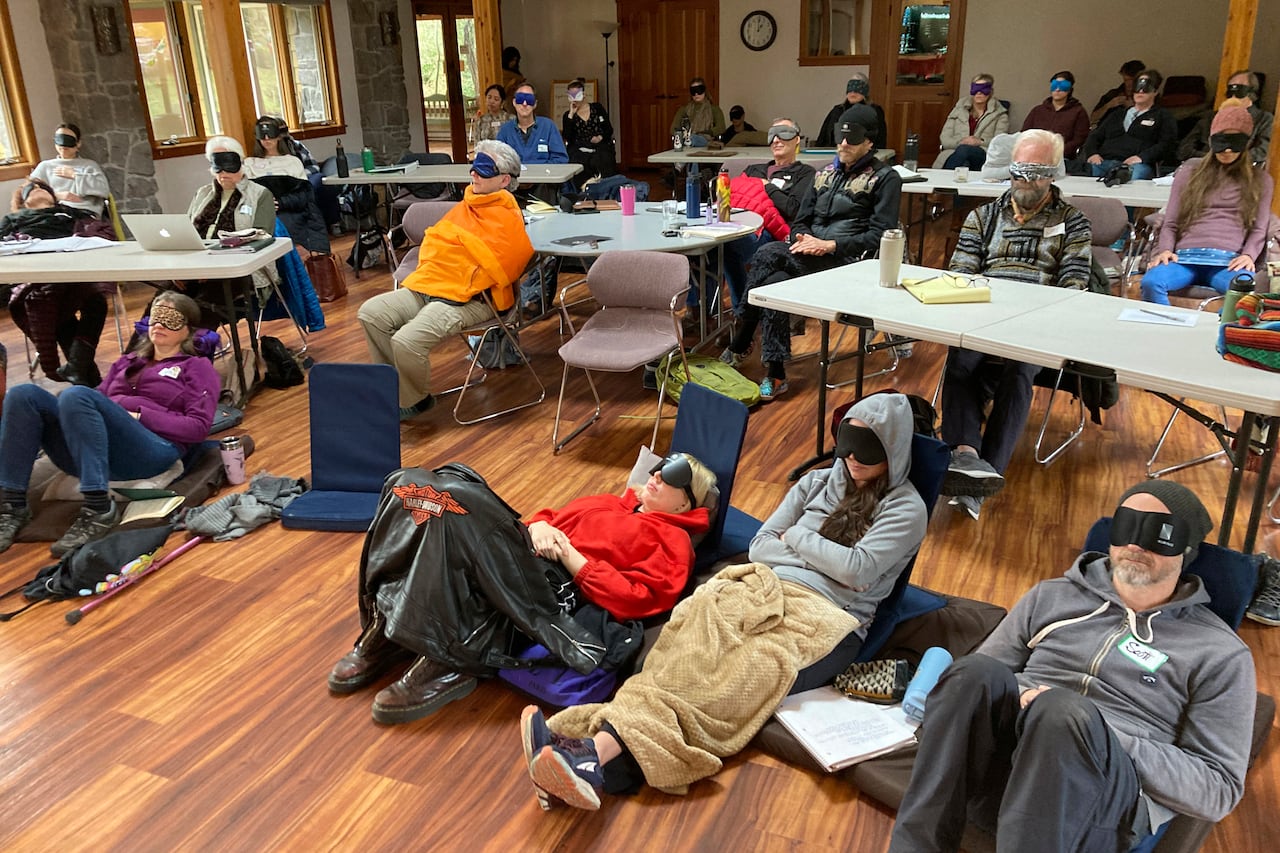Psilocybin facilitator students sit with eye masks on while listening to music during an experiential activity at a training session run by InnerTrek near Damascus, Ore., on Dec. 2, 2022. The students were trained in how to accompany patients trippin