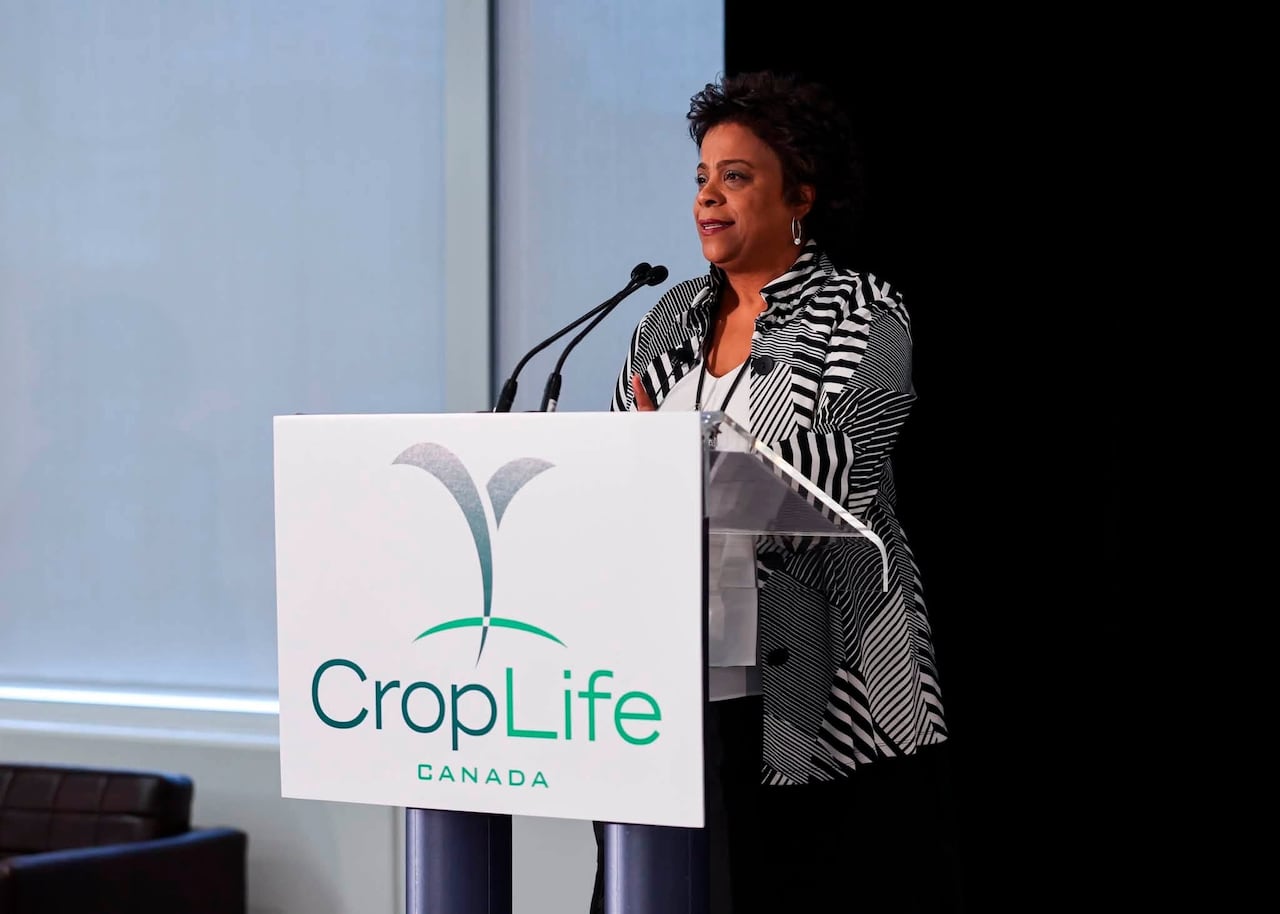 A woman stands at a podium.