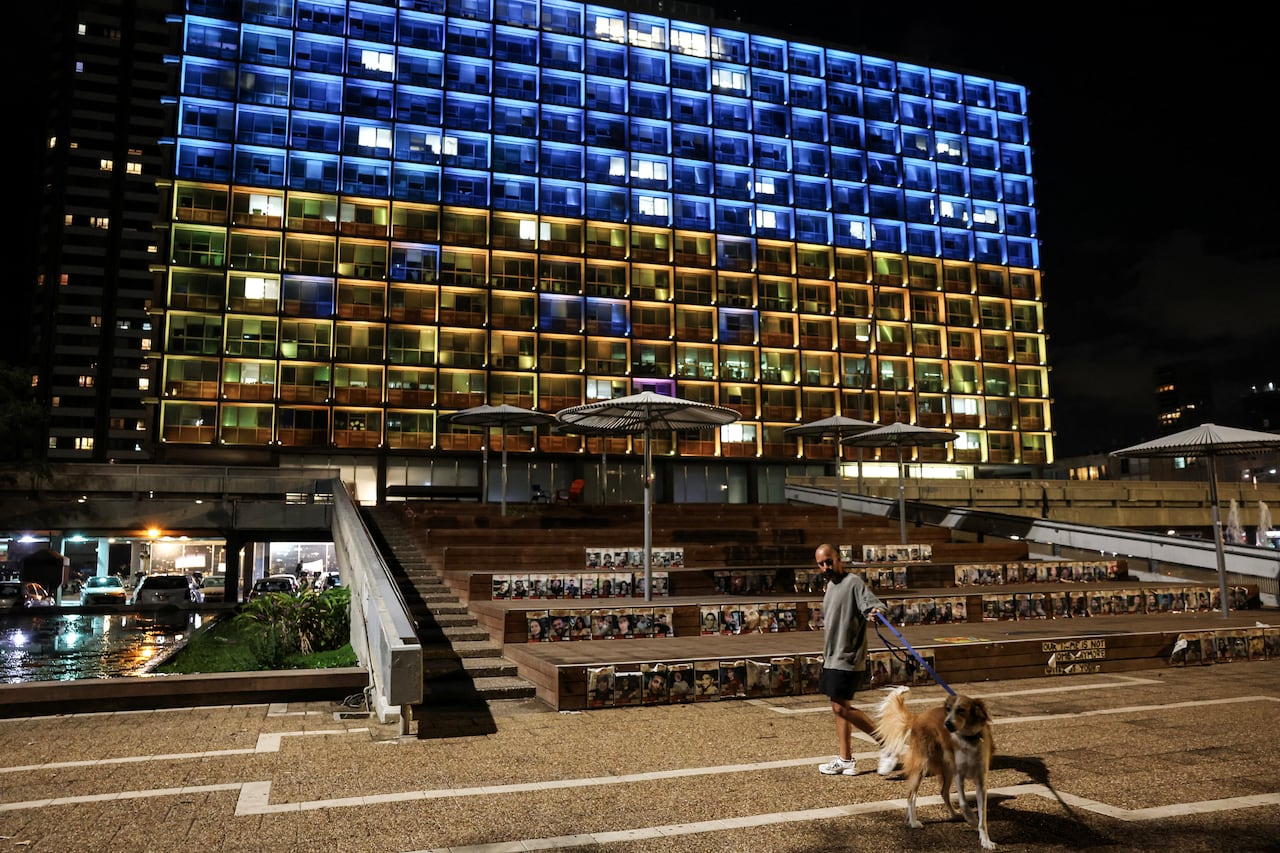A building lit up in blue and yellow.