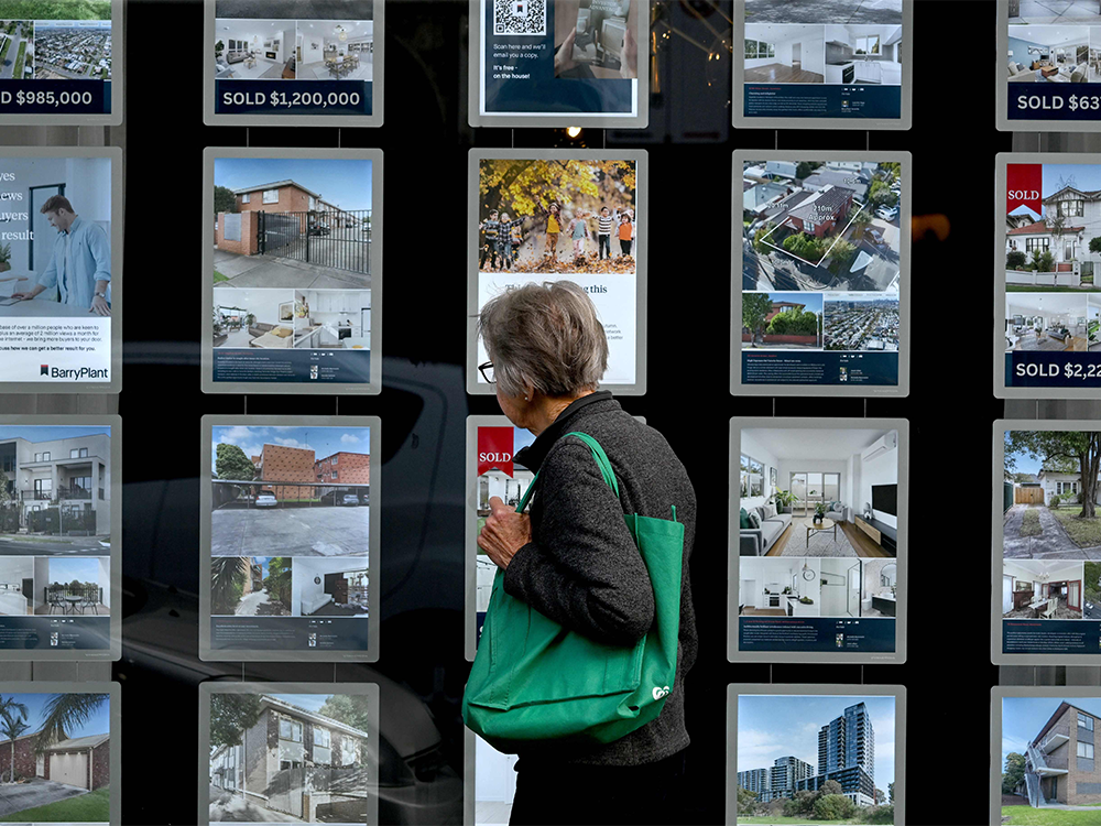 Woman looks at housing listings in Melbourne
