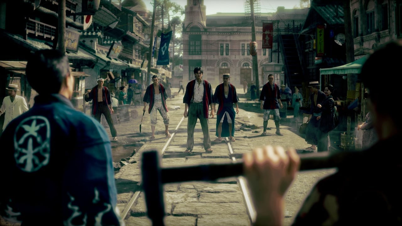 Video game screenshot of men staring down each other in a crowded Japanese street.