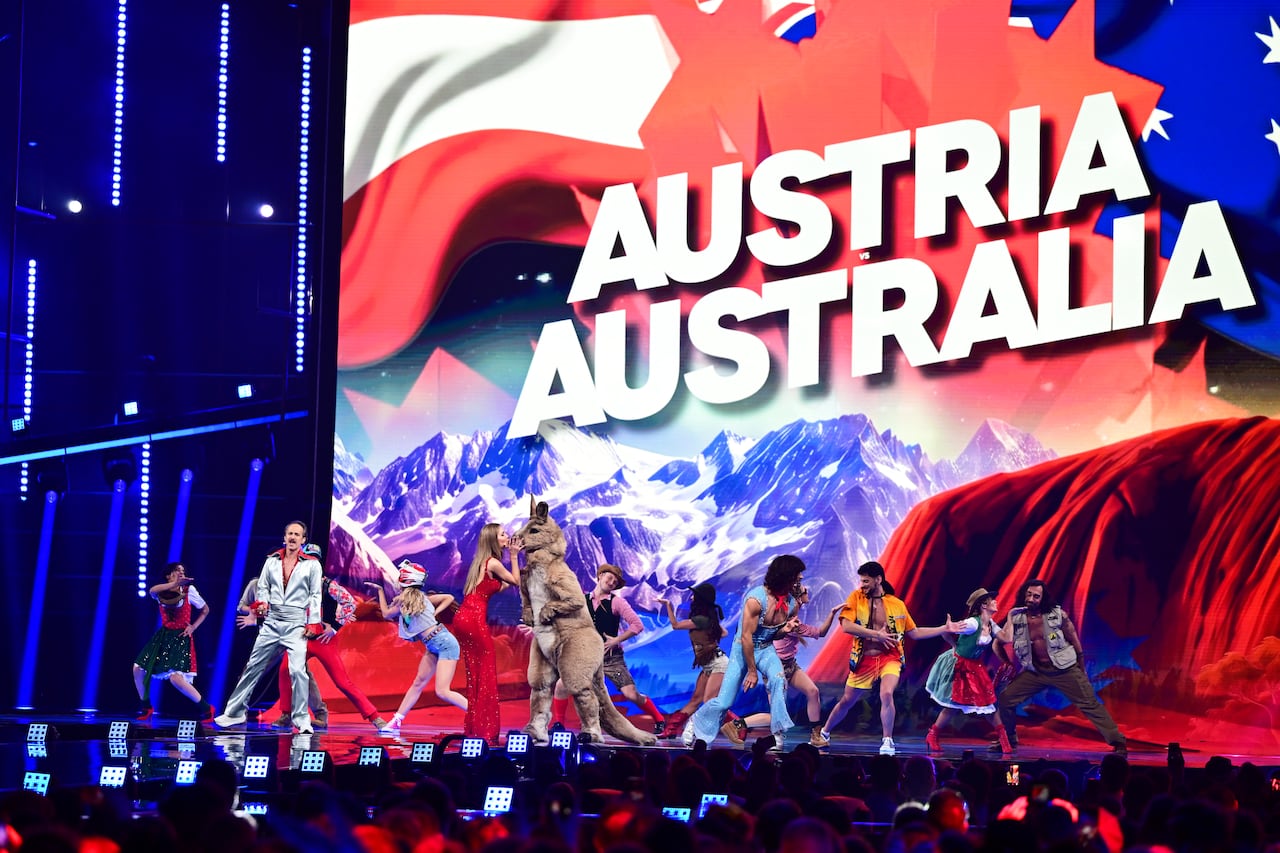 Dancers on stage with Austria Australia sign.