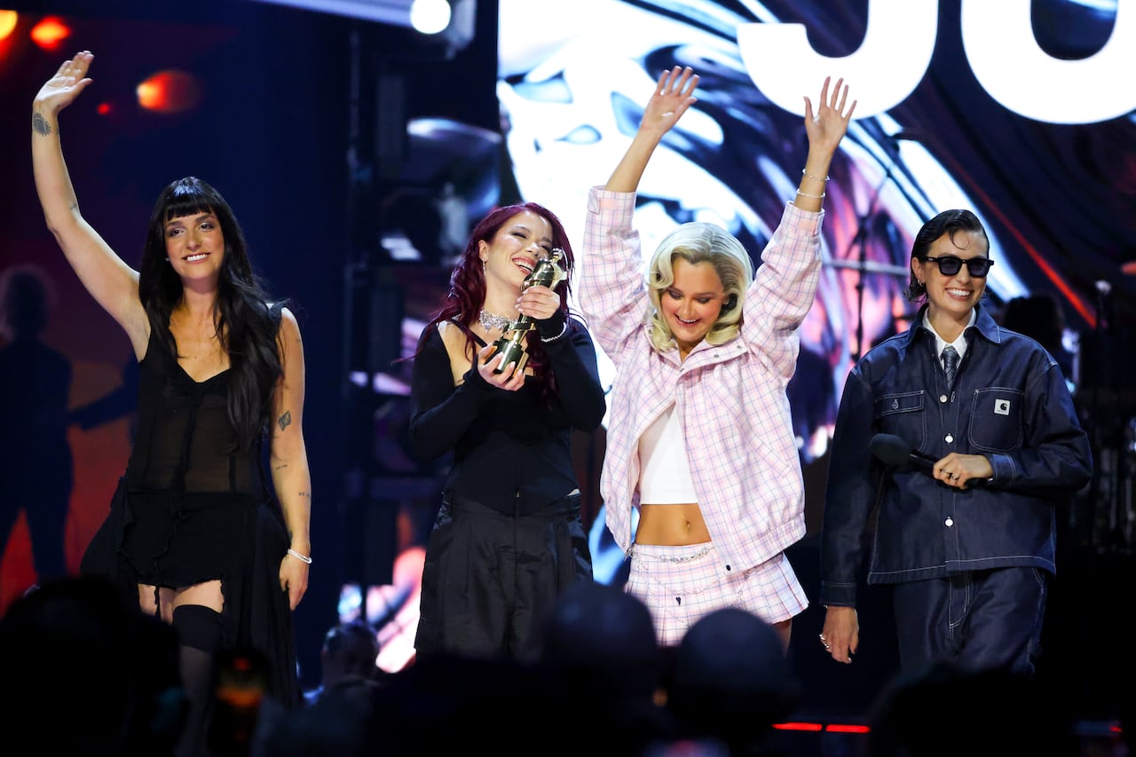 Four women dressed on stage.
