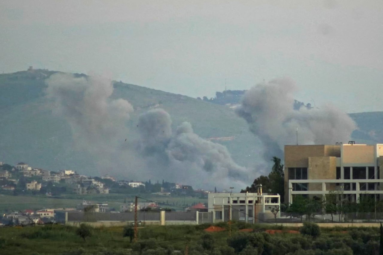 Smoke rises from an airstrike on a building.