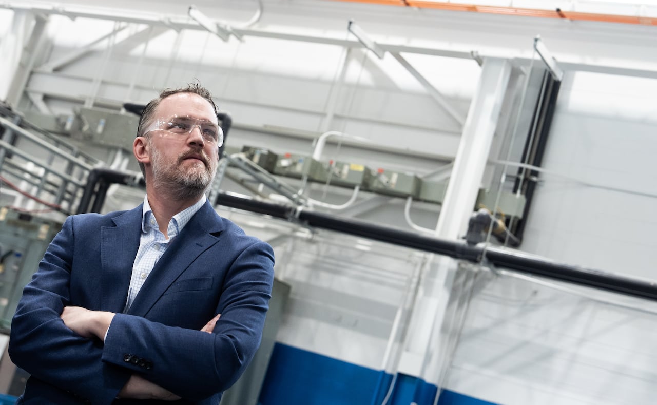 Jamieson Greer, wearing protective glasses, stands in a factory.