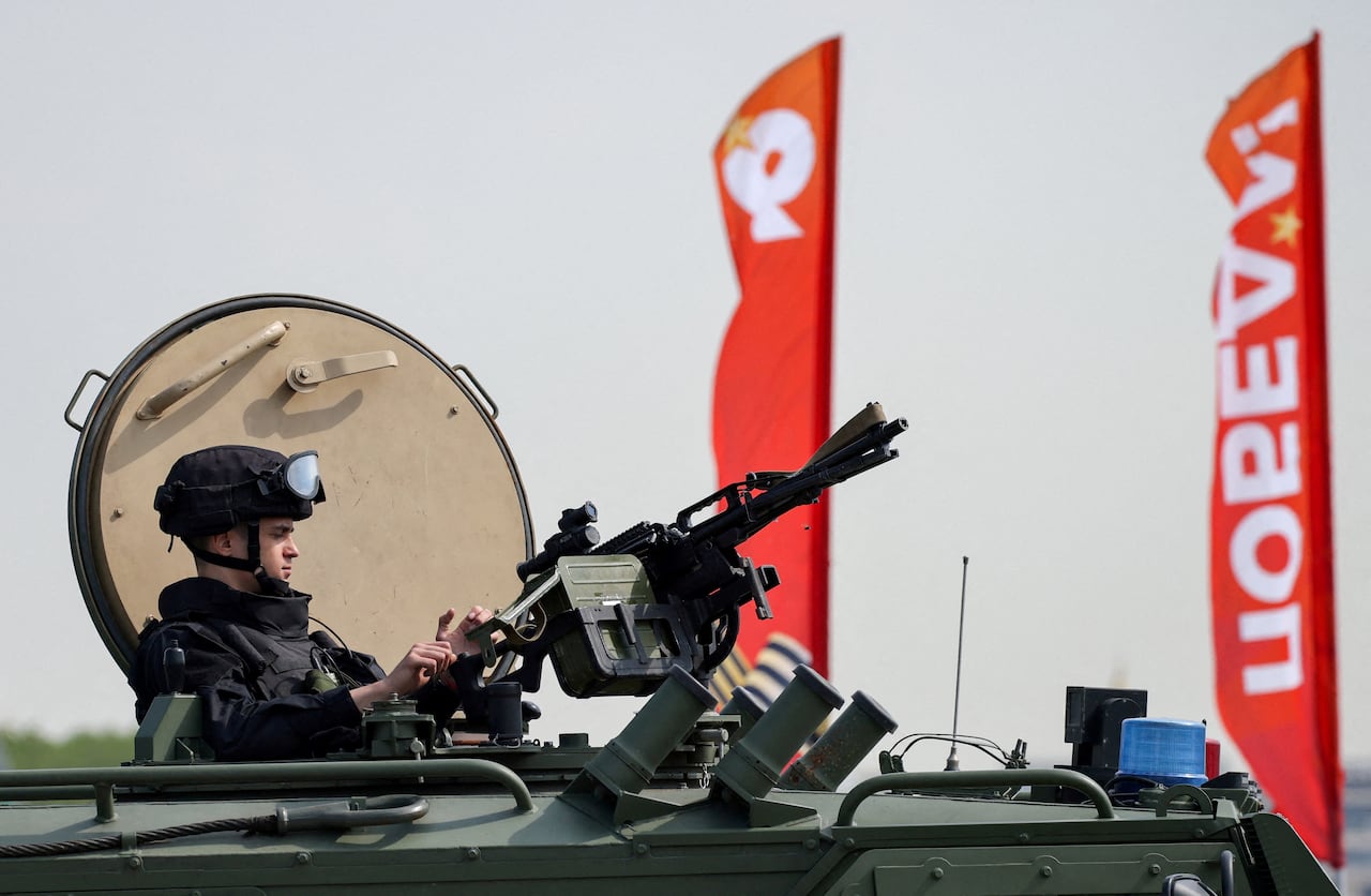 A soldier sits in a tank.