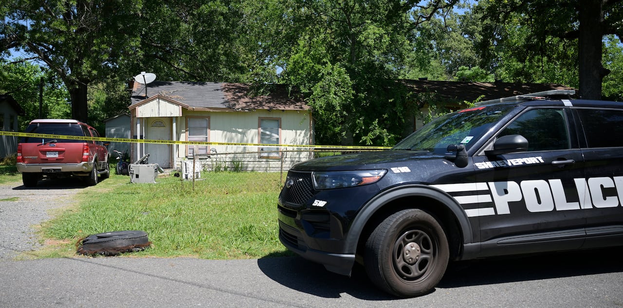 A police SUV parked in front of a house