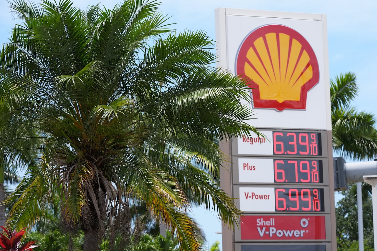 An electronic board at a Shell gas station displays the current prices for various types of fuel.