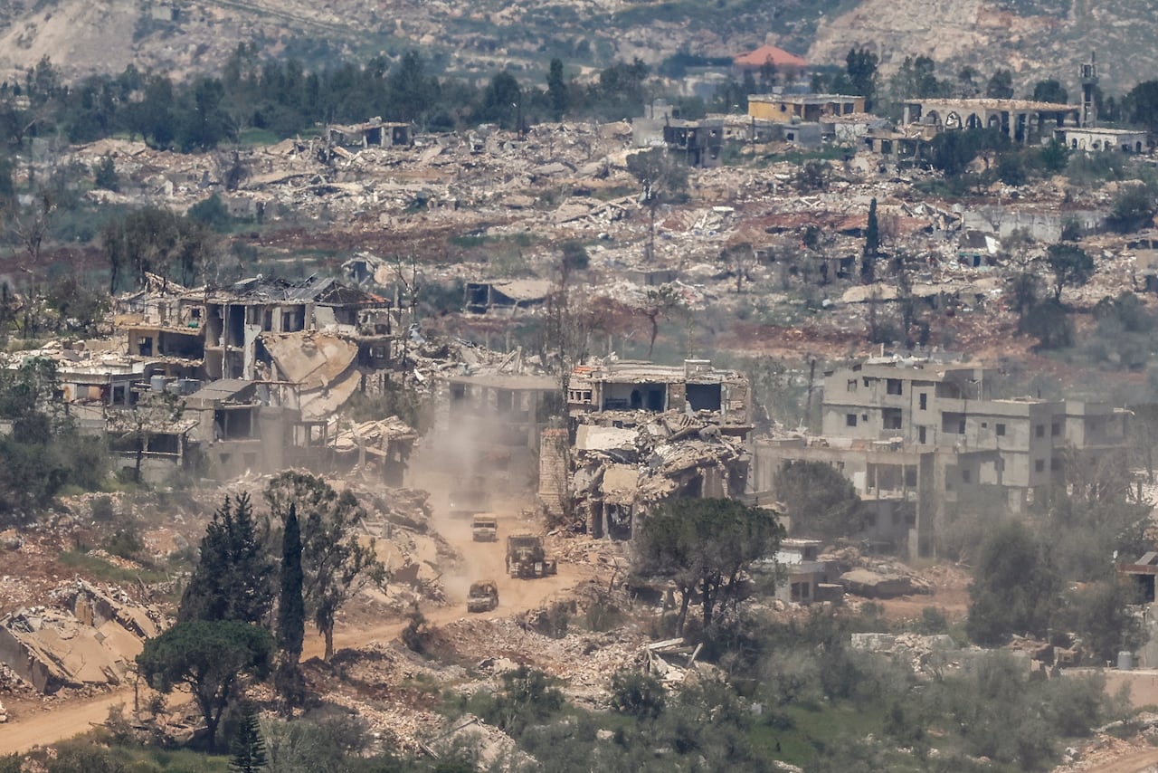 From an aerial view, buildings at the bottom of a hill are shown with significant damage.