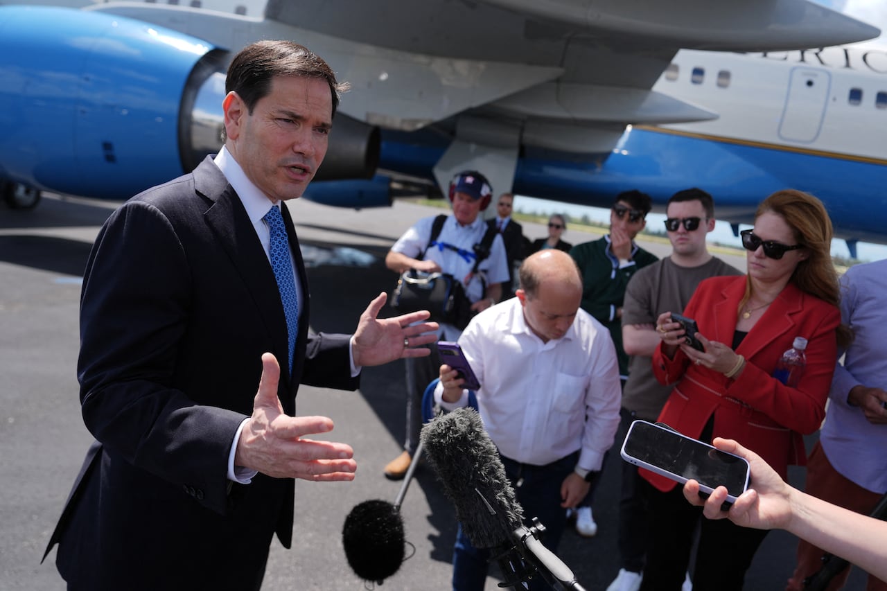 U.S. Secretary of State Marco Rubio gestures with his arms outstretched, while speaking to a group of reporters in Florida.