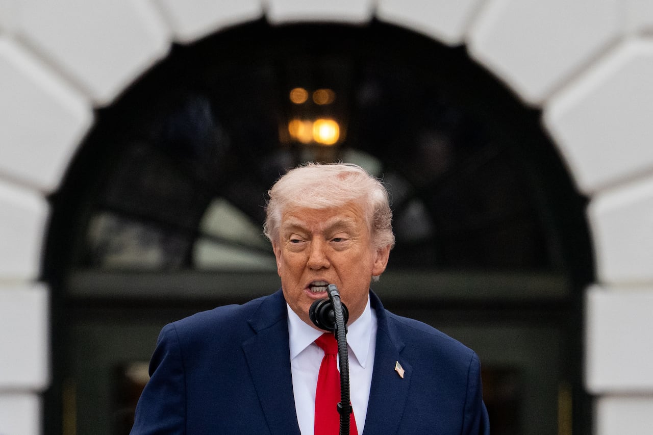 U.S. President Donald Trump speaking, while standing in front of a microphone
