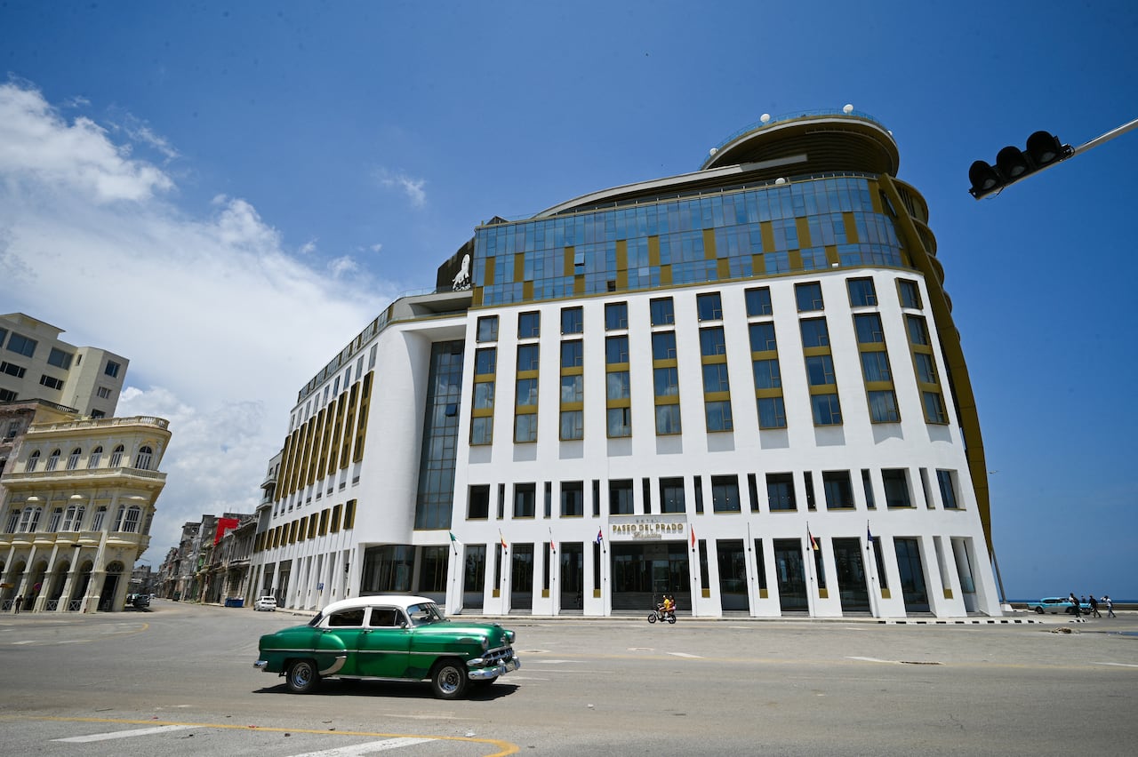 A classic car drives past the Paseo del Prado Hotel in Havana, Cuba.