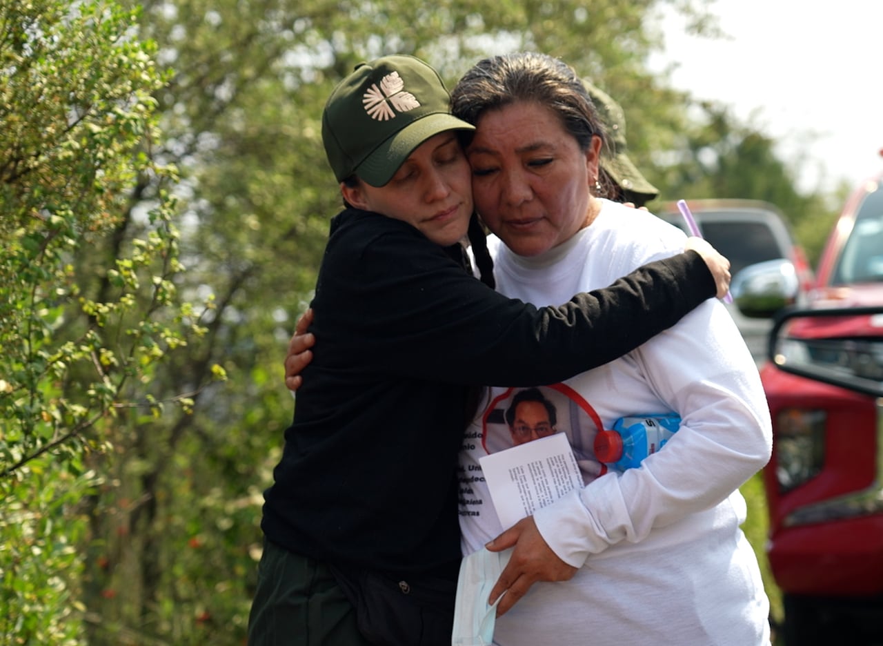 Two women hugging each other.
