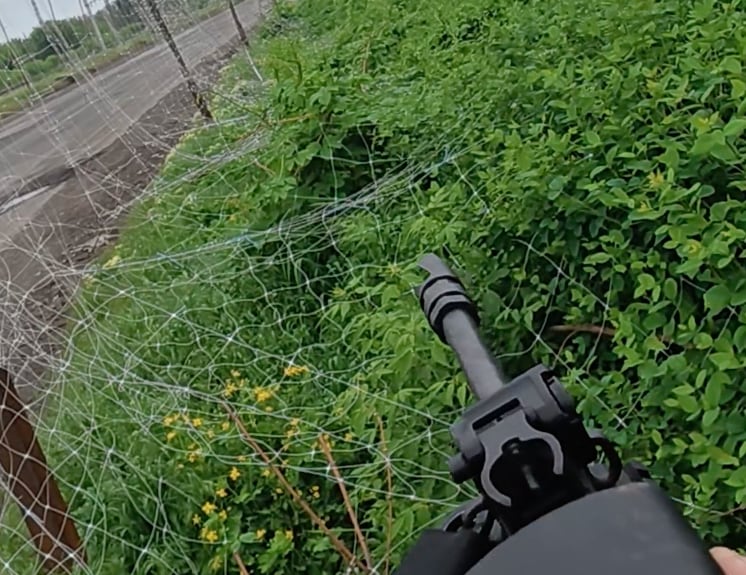 In this photo provided to CBC news by the 24th Mechanized Brigade, a soldier aims his gun at the sky in an attempt to bring down a Russian drone.
