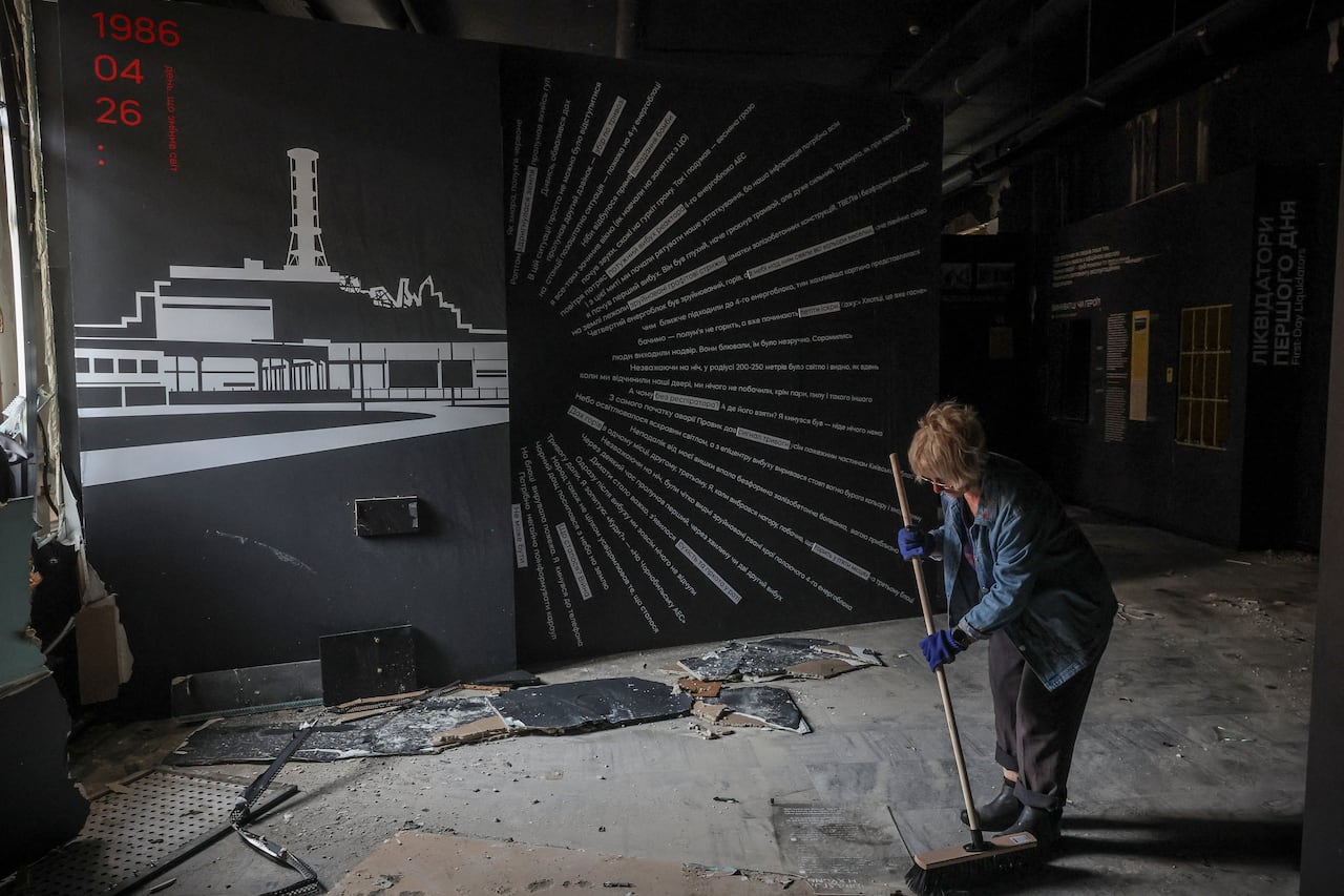 A woman cleans up inside of the building.