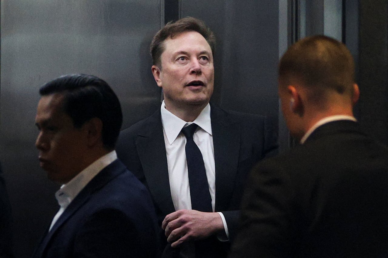 Elon Musk stands in an elevator