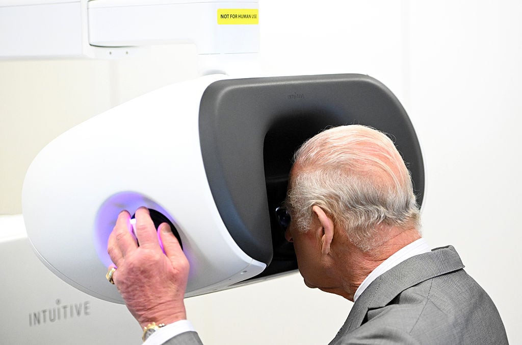 A person looks into a surgery robot.