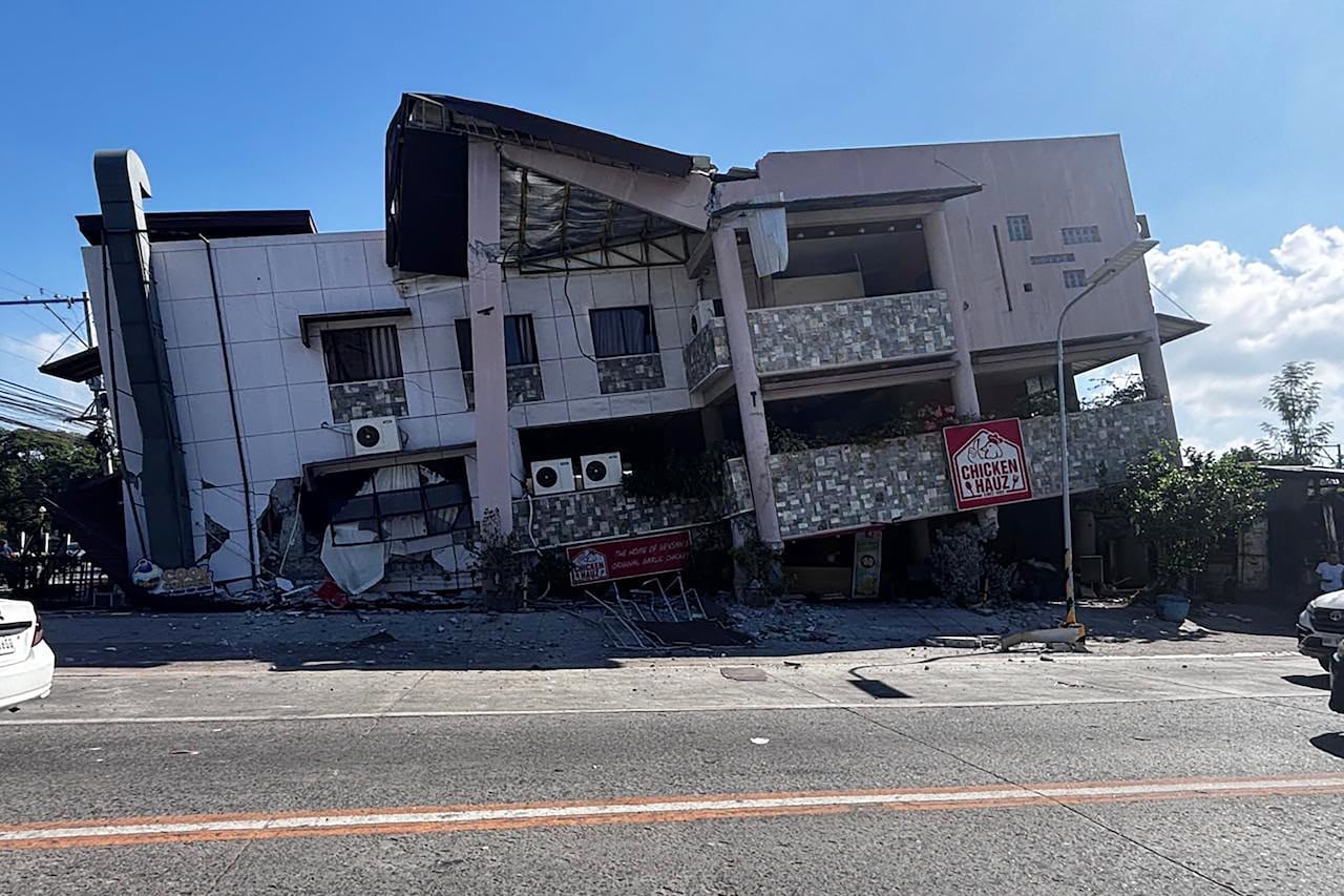 A two-storey building is intact but leaning over.