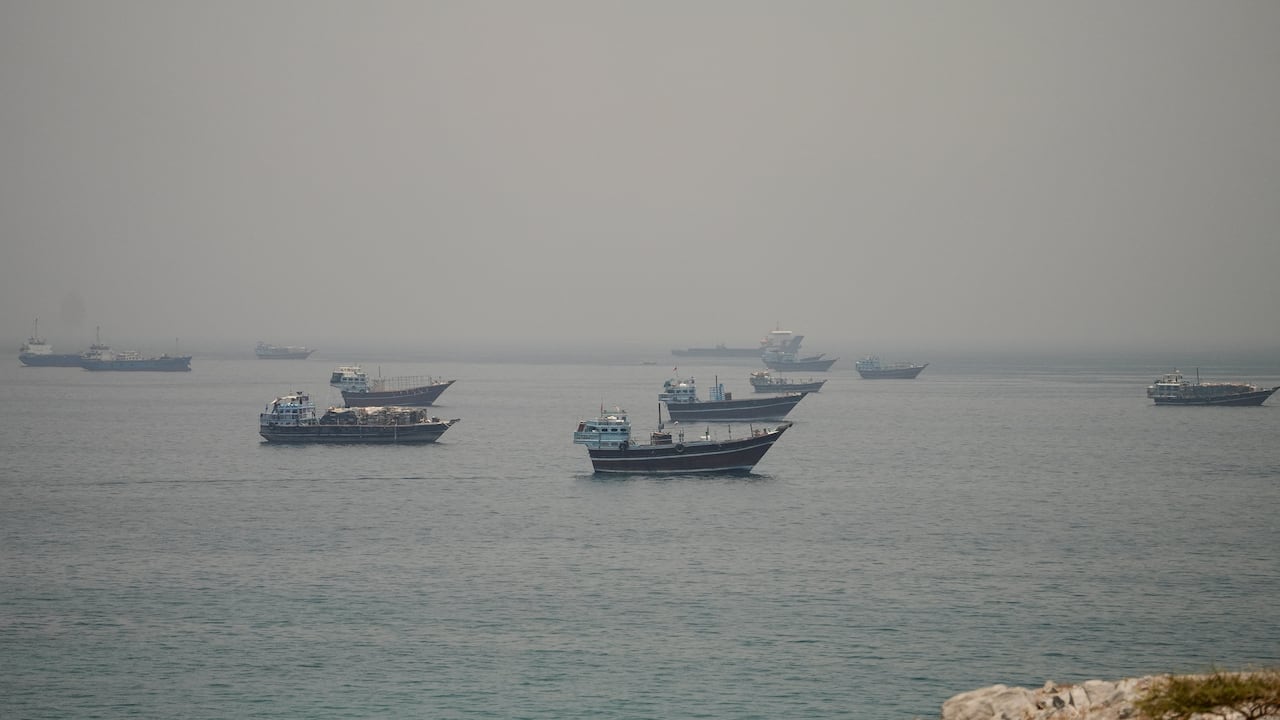 Ships are shown from a distance in a large body of water.